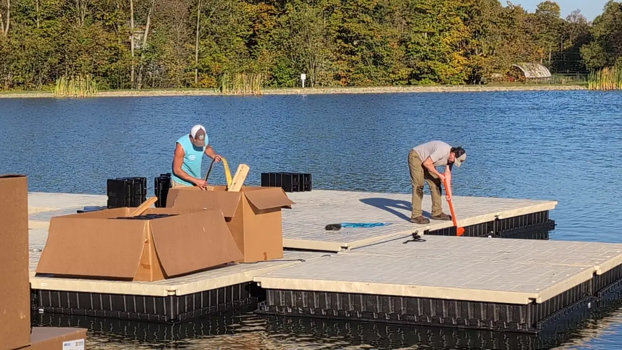 Video still of the crew working on the floating platform during assembly.