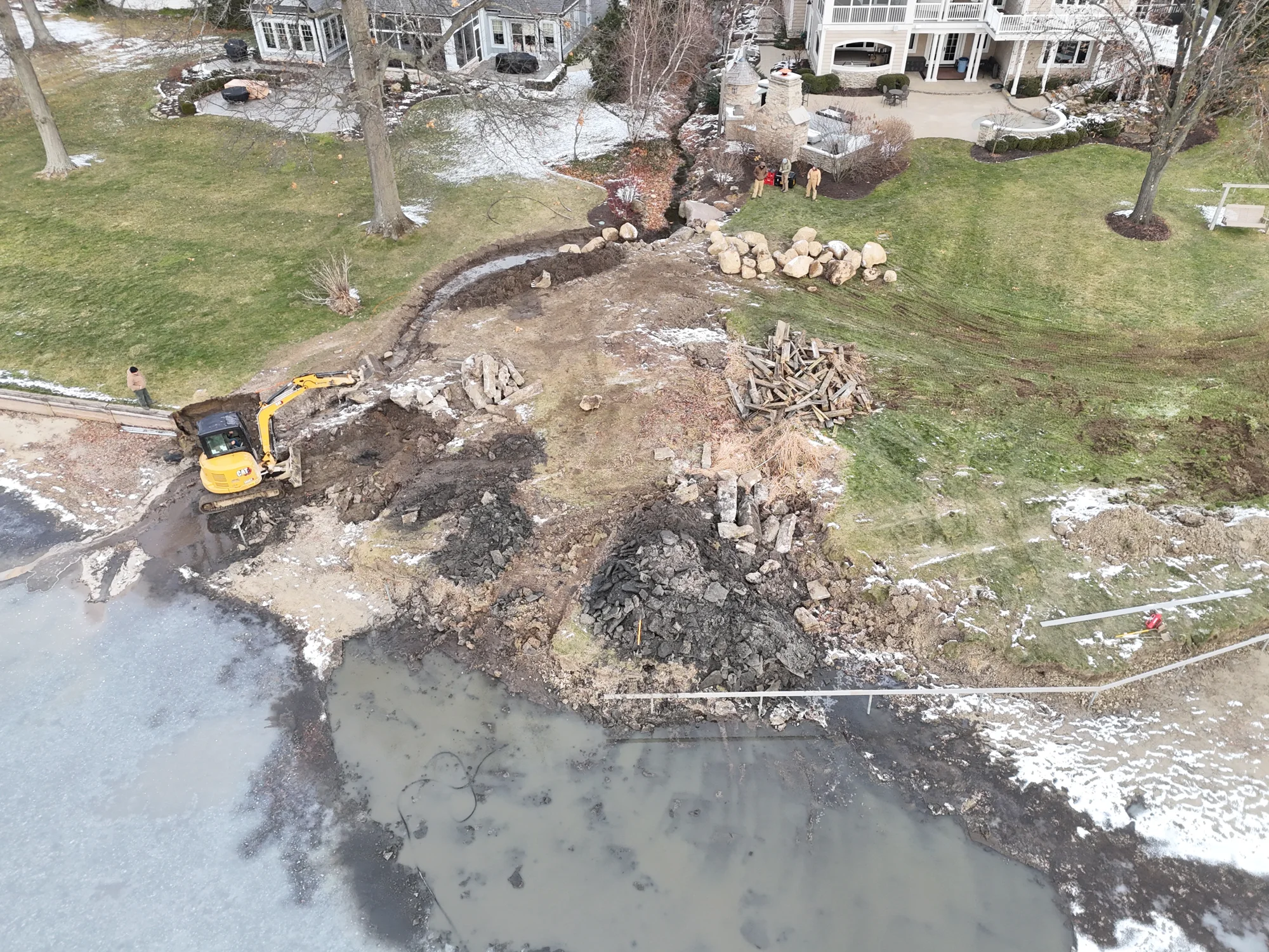 Excavation and boulders along the shoreline during construction.