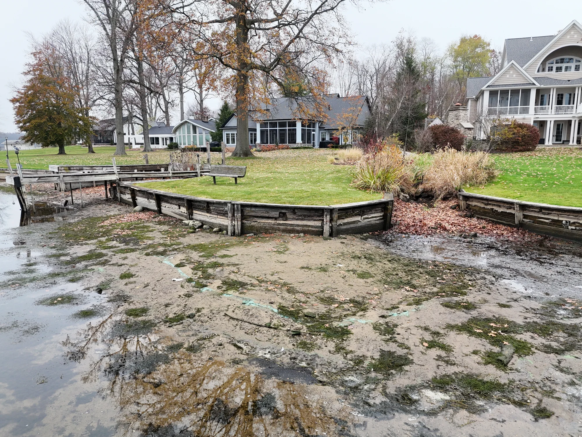 The original timber shoreline edge and dock beside the drainage channel.