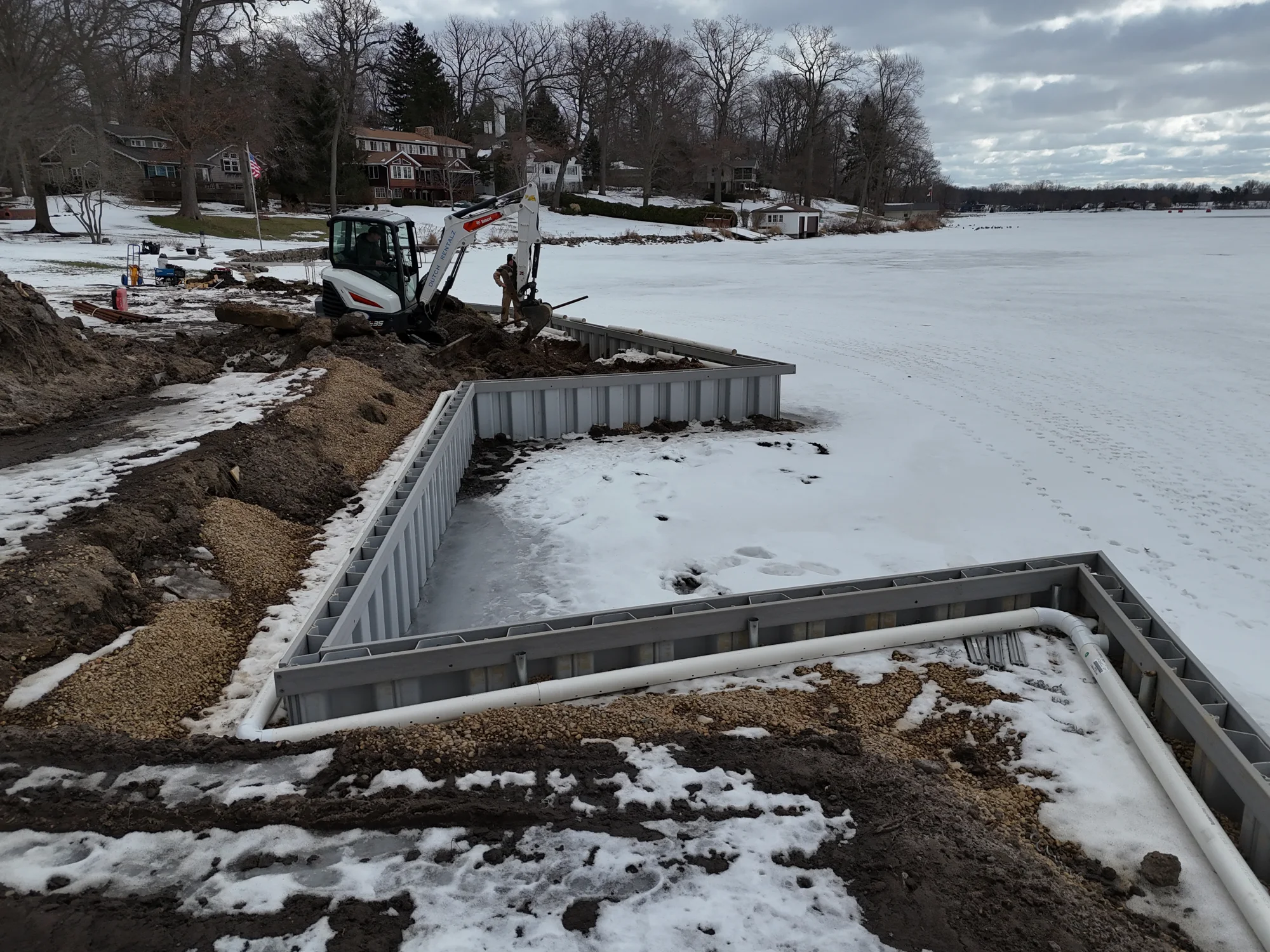 New seawall outlining the excavated boat berths during winter construction