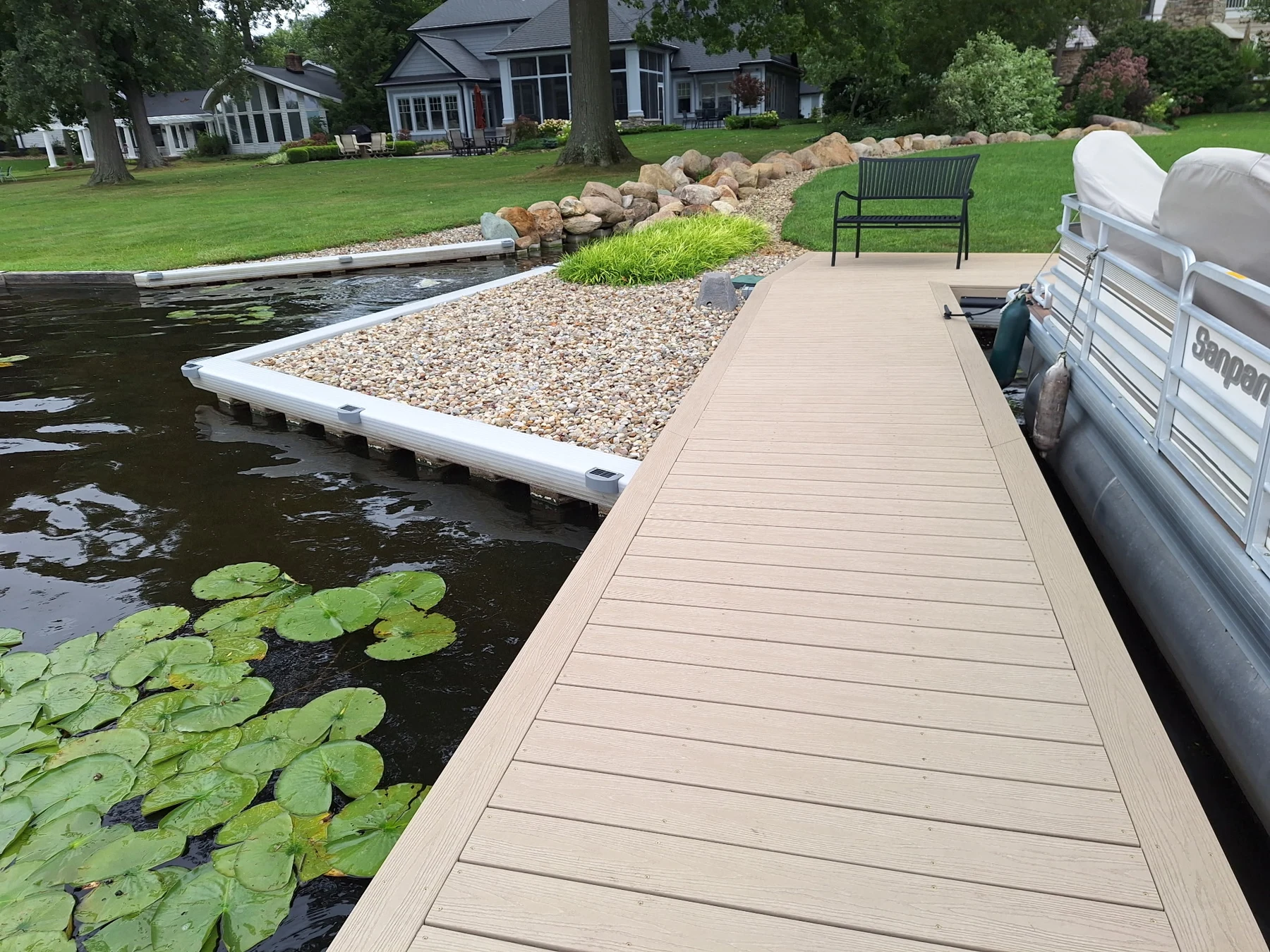 The dock walkway, seawall cap, stone border and bench.