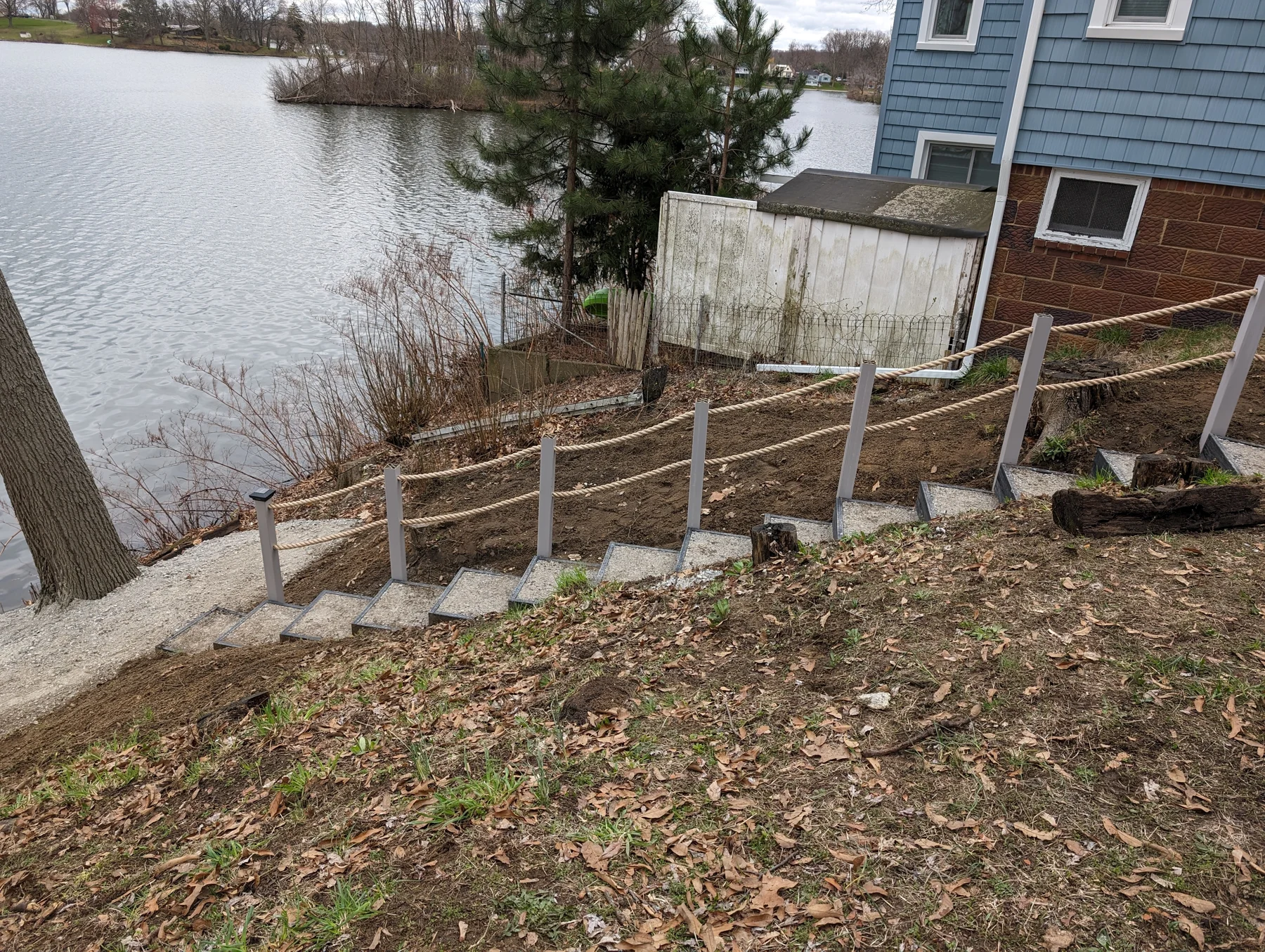 Side view of the completed steps, posts and rope beside Hilltop Lakehouse.