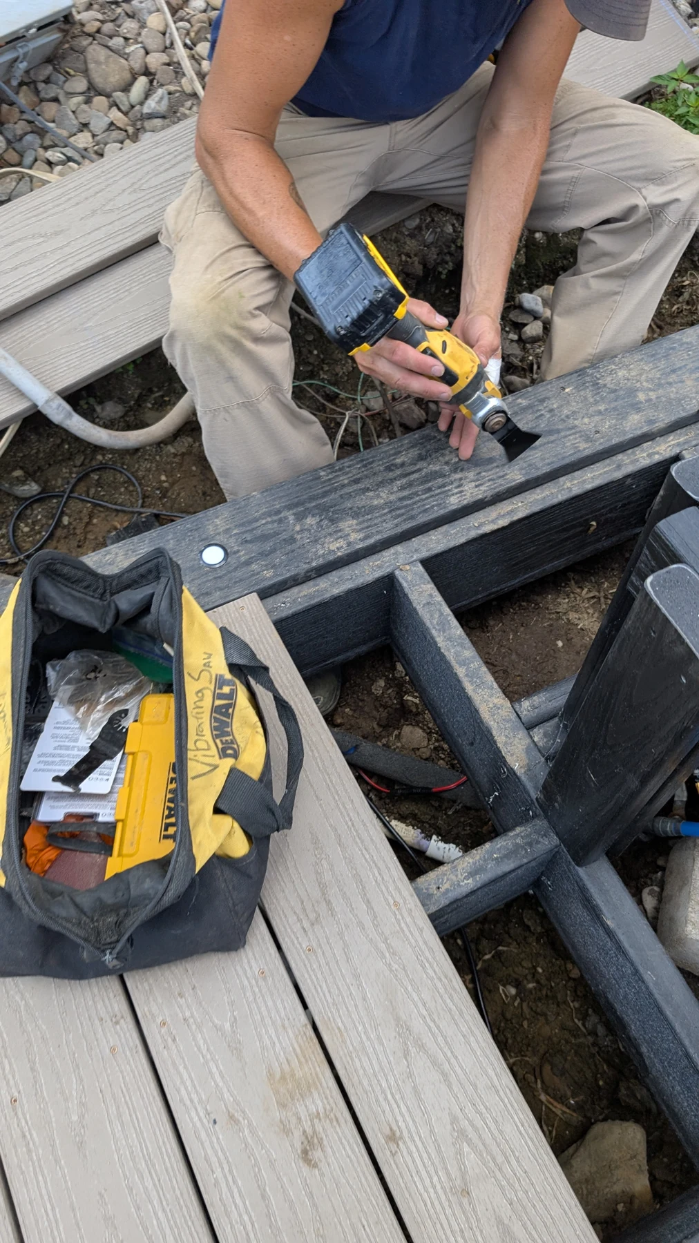 A crew member fastening components to the framing at the shoreline.