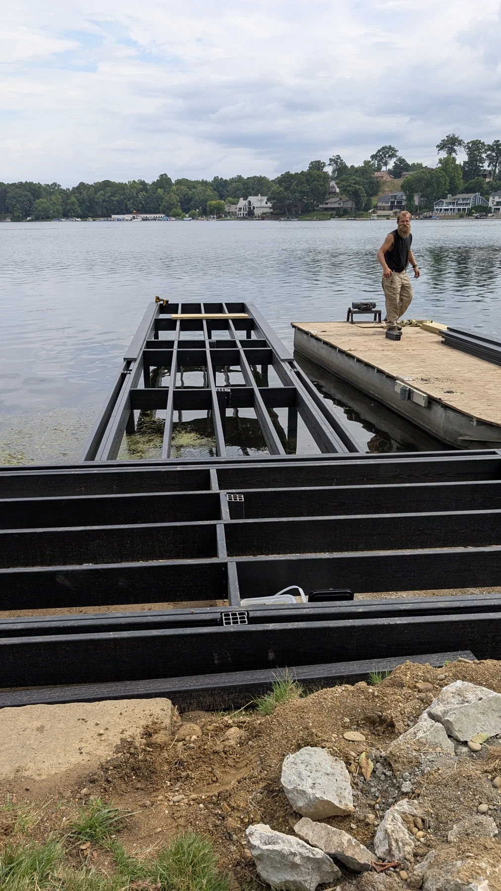 The boardwalk framing positioned beside the water during installation.
