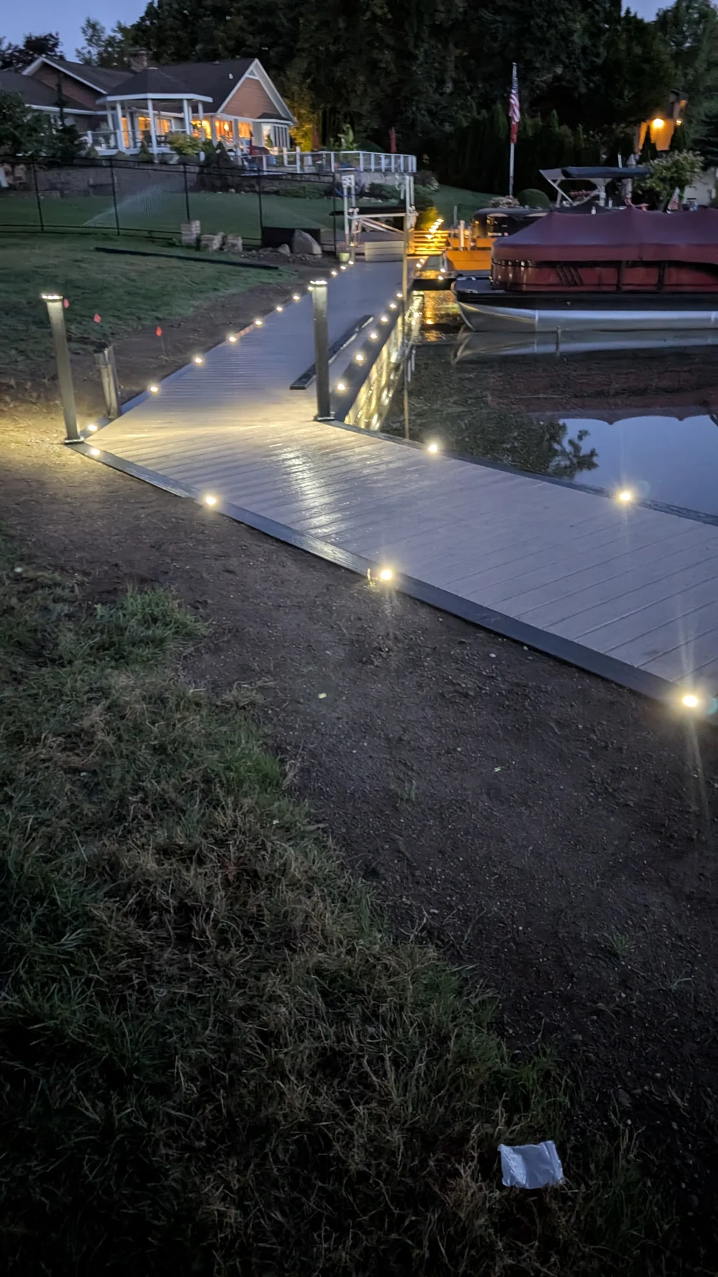 Integrated deck and post lighting illuminates the finished boardwalk in the early morning.