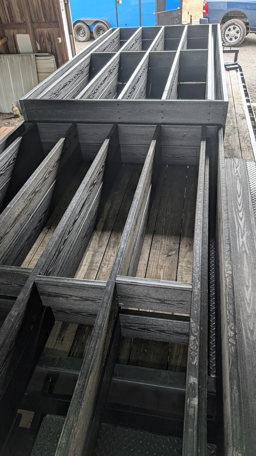 Dark structural members assembled into a boardwalk frame in the workshop.