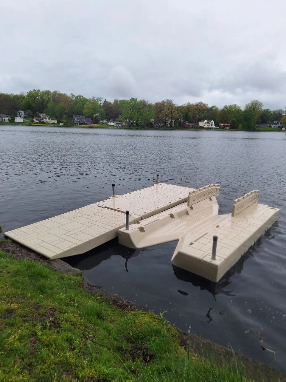 A kayak launch connected alongside a floating dock at the lakeshore.