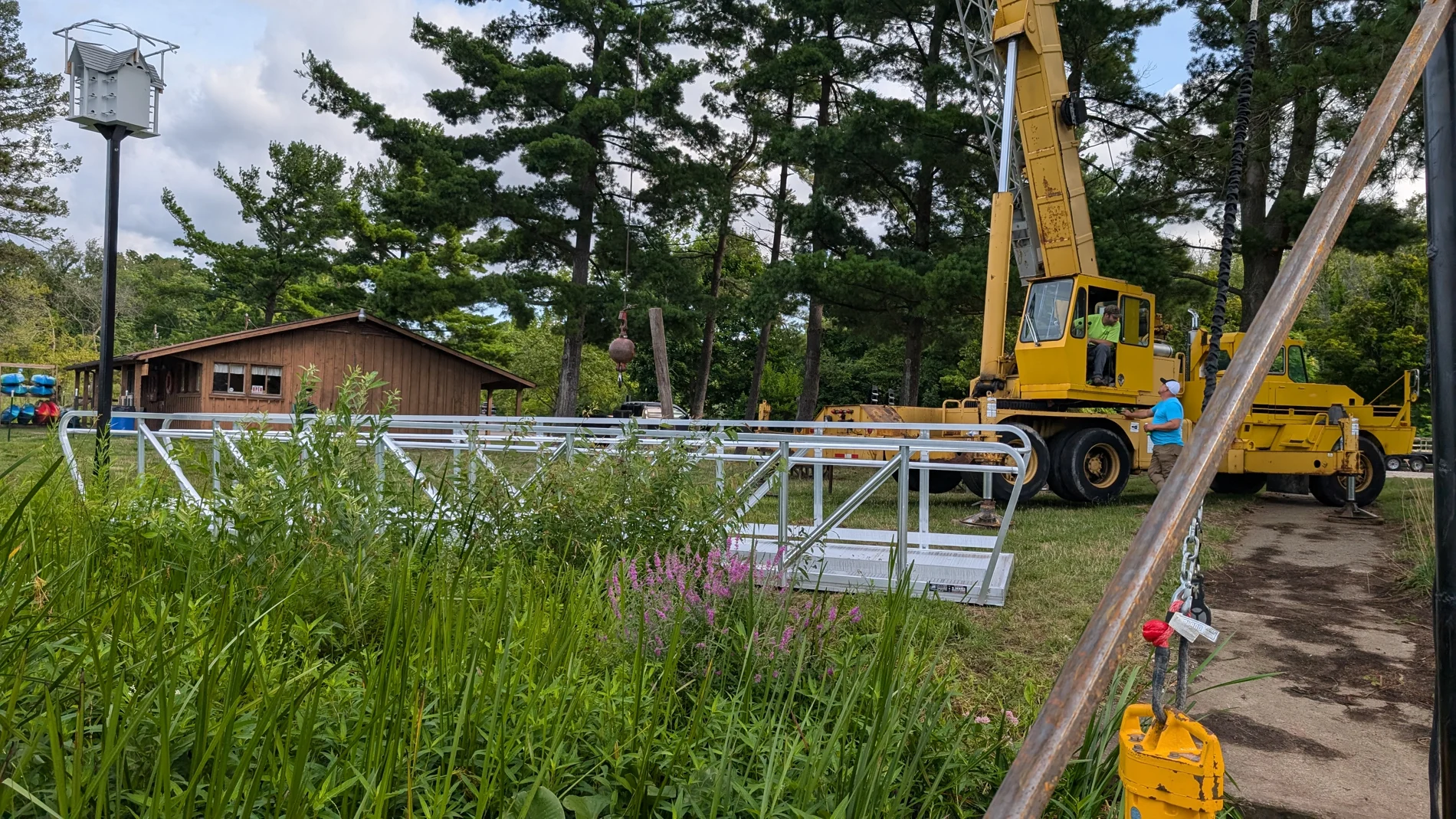 A crane positioned beside the staged gangway at the reservoir.