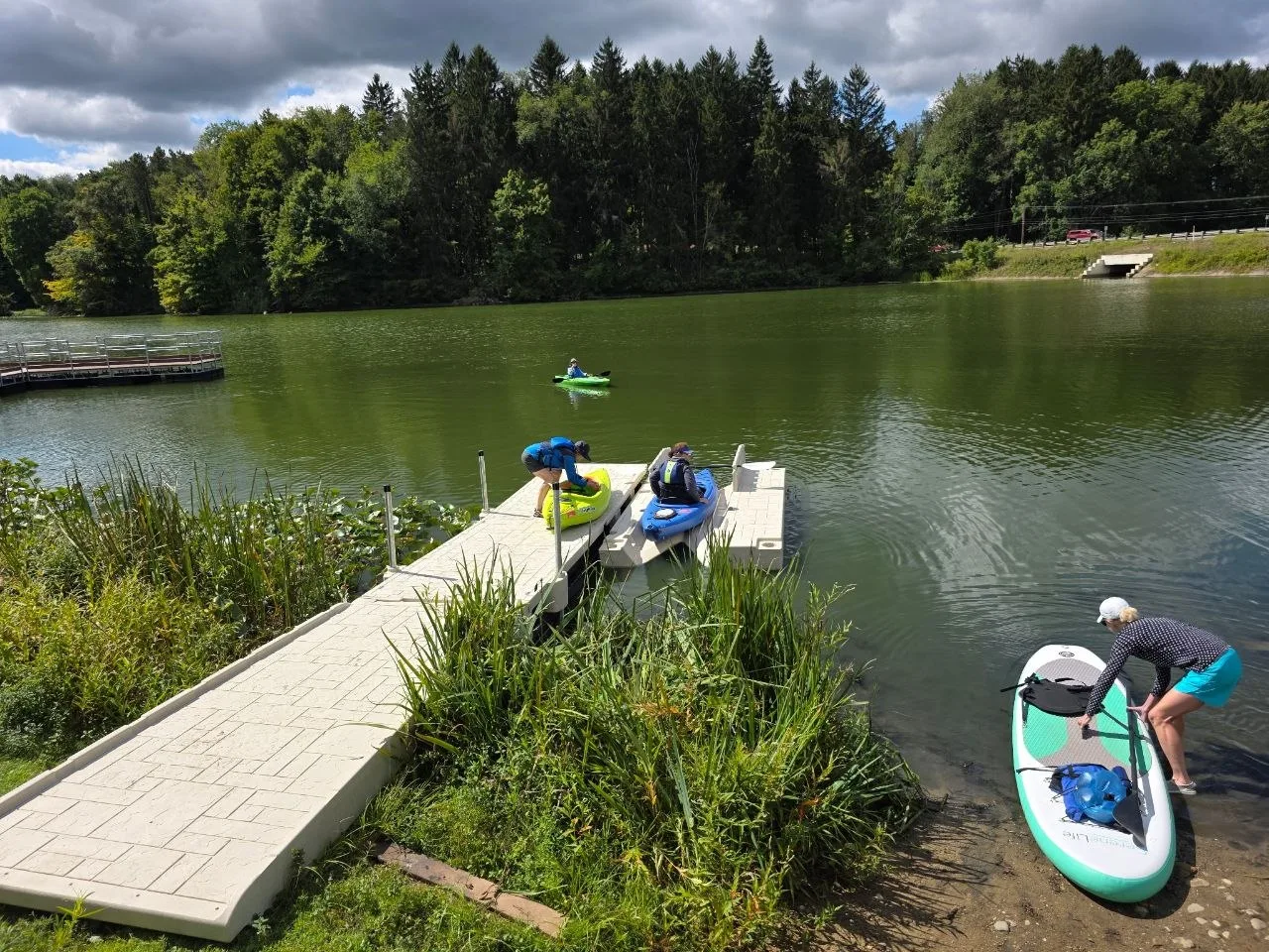 Paddlers using the installed floating dock and kayak launch at Mogadore Reservoir