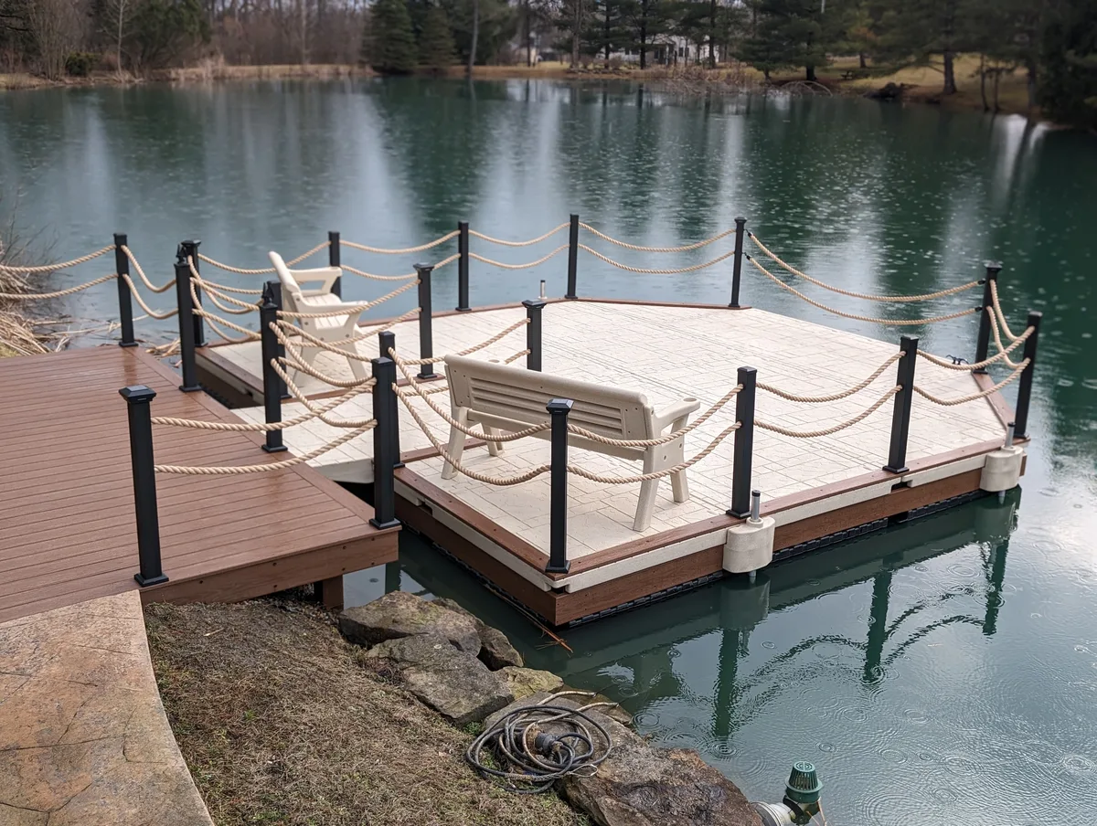 Custom floating pond platform with two benches, dark posts and nautical rope
