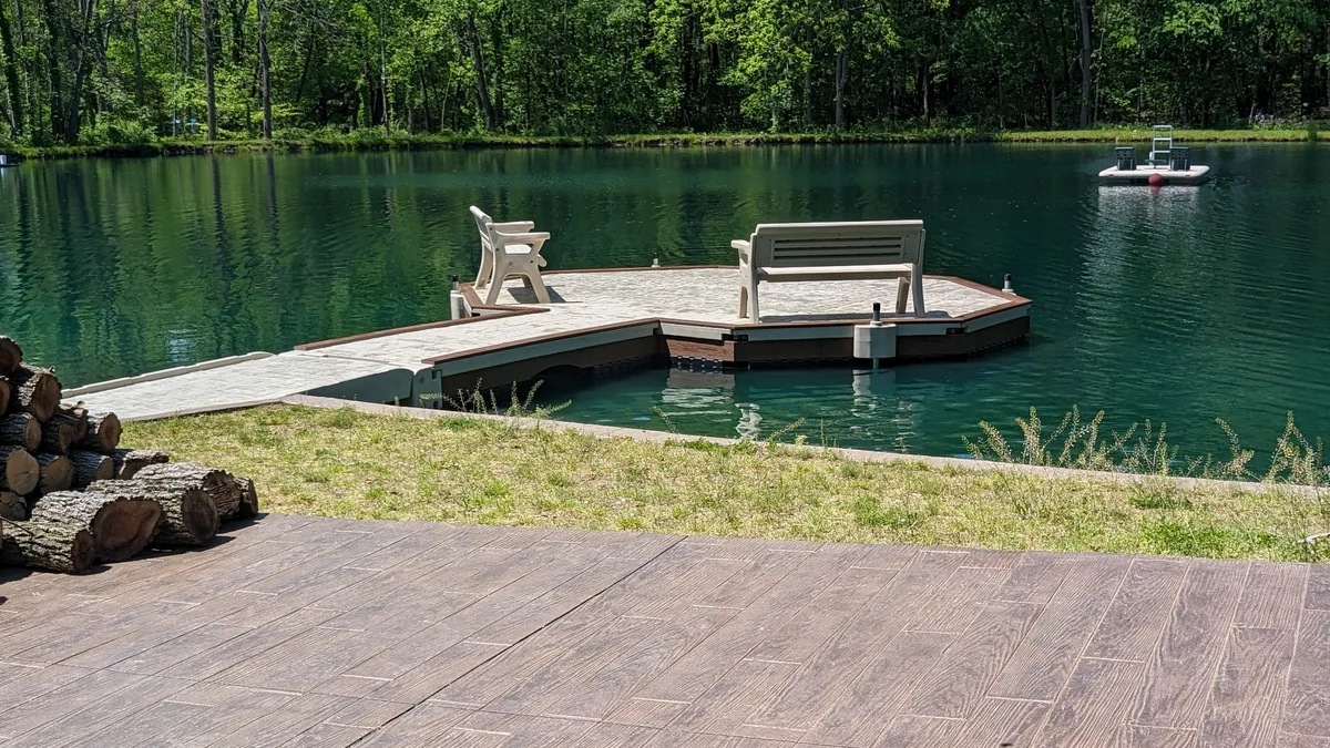 Pond dock with two benches and a separate swim raft farther out on the water