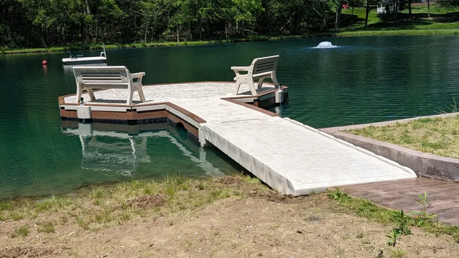 Custom floating pond dock with seating at the property