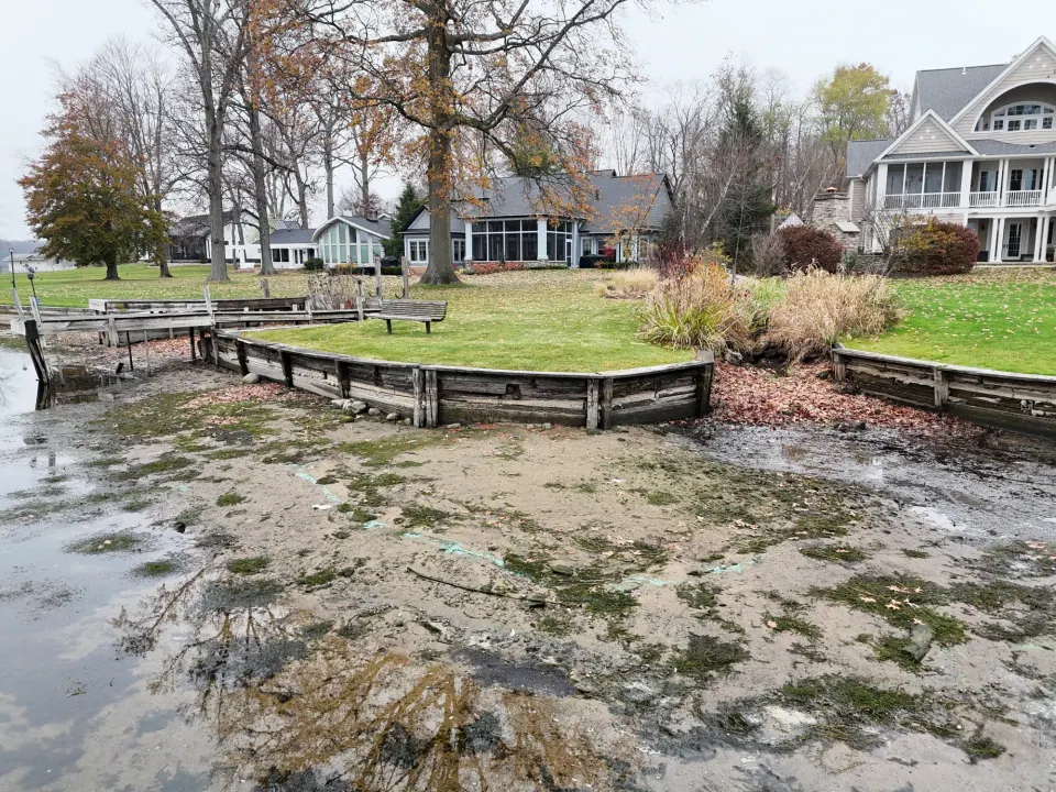 The original timber shoreline edge and dock beside the drainage channel.