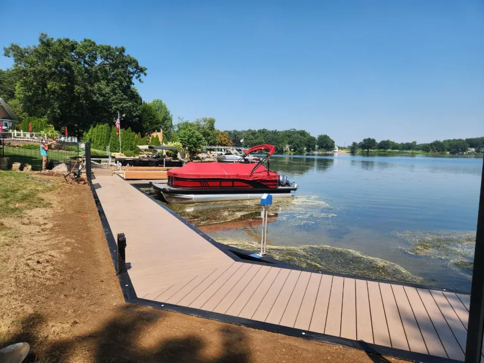 Tan WearDeck boardwalk with a dark picture-frame border along Mud Lake