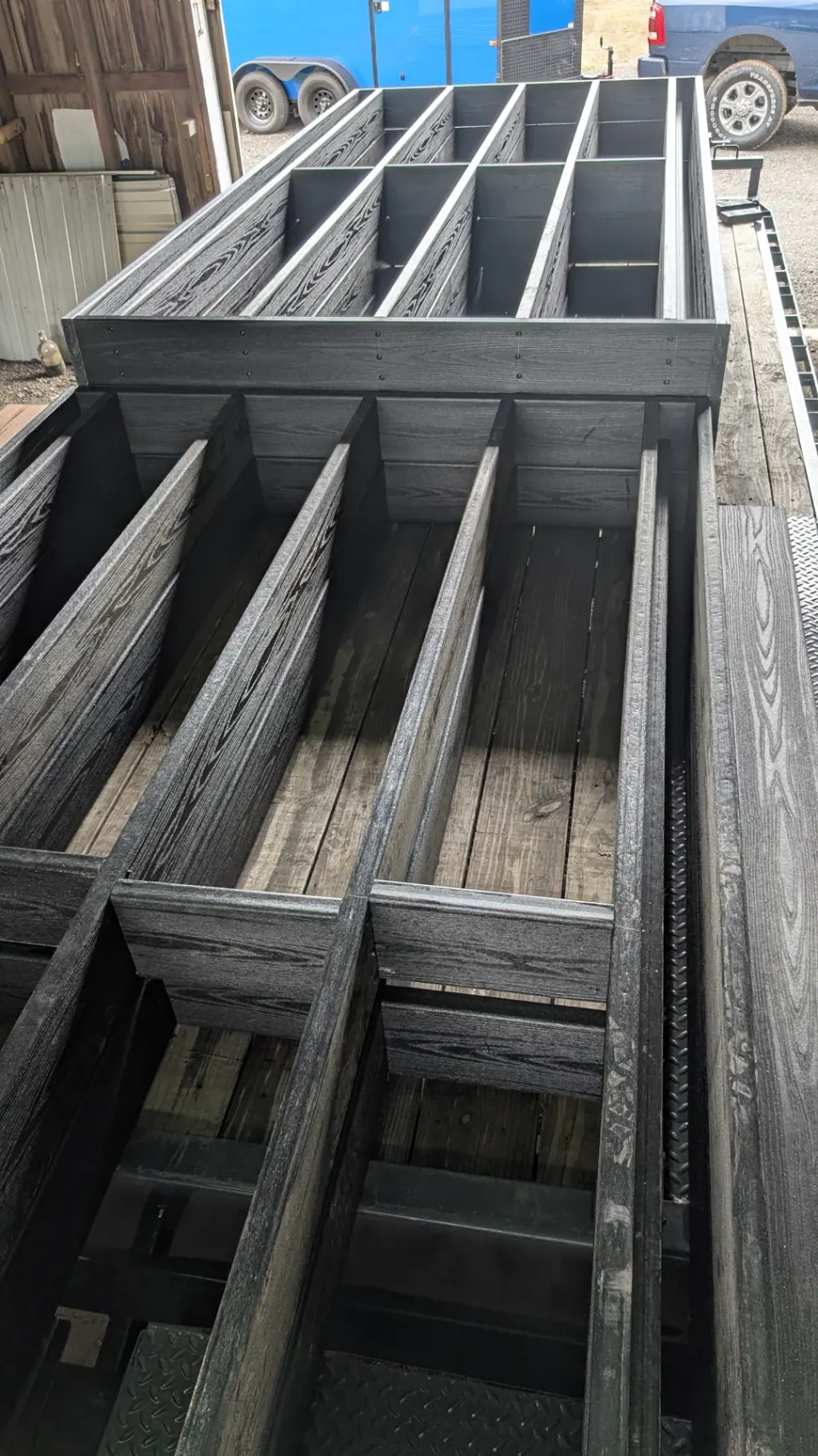 Dark structural members assembled into a boardwalk frame in the workshop.