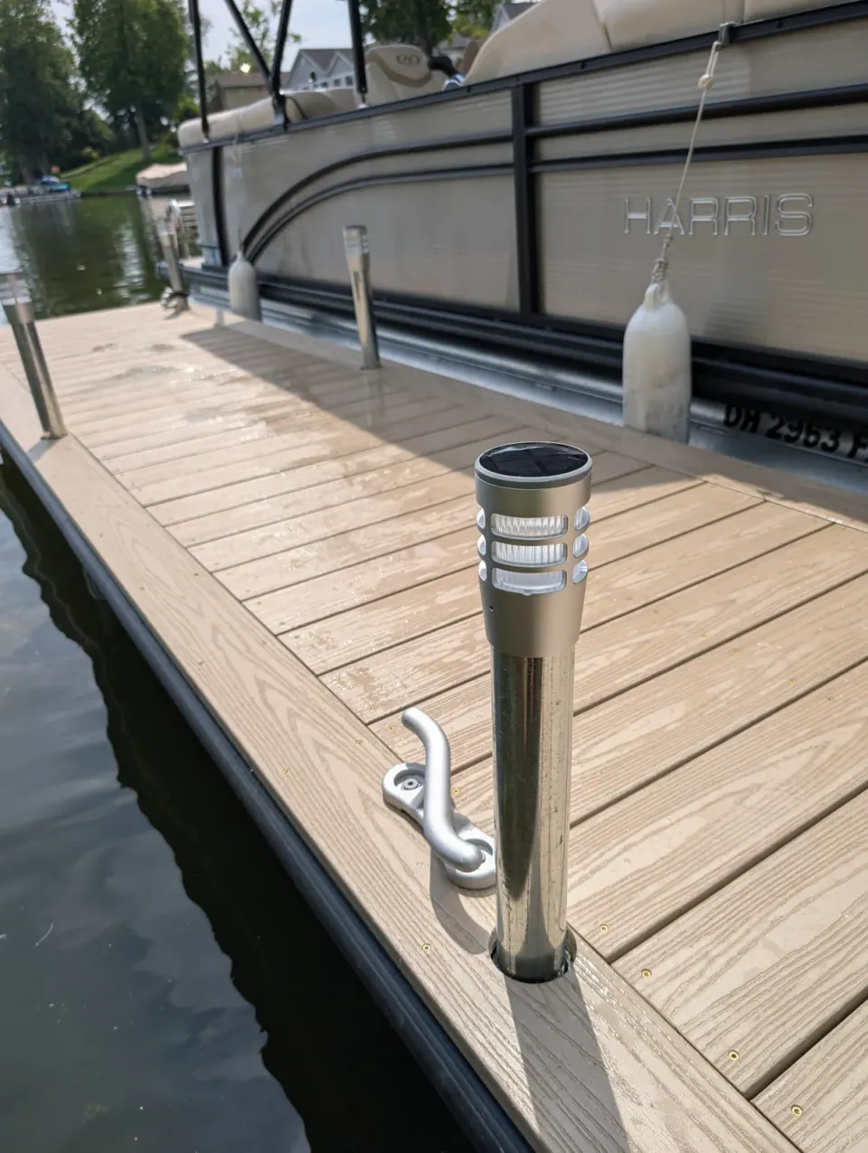 A solar post light and aluminum cleat beside the picture-framed decking.