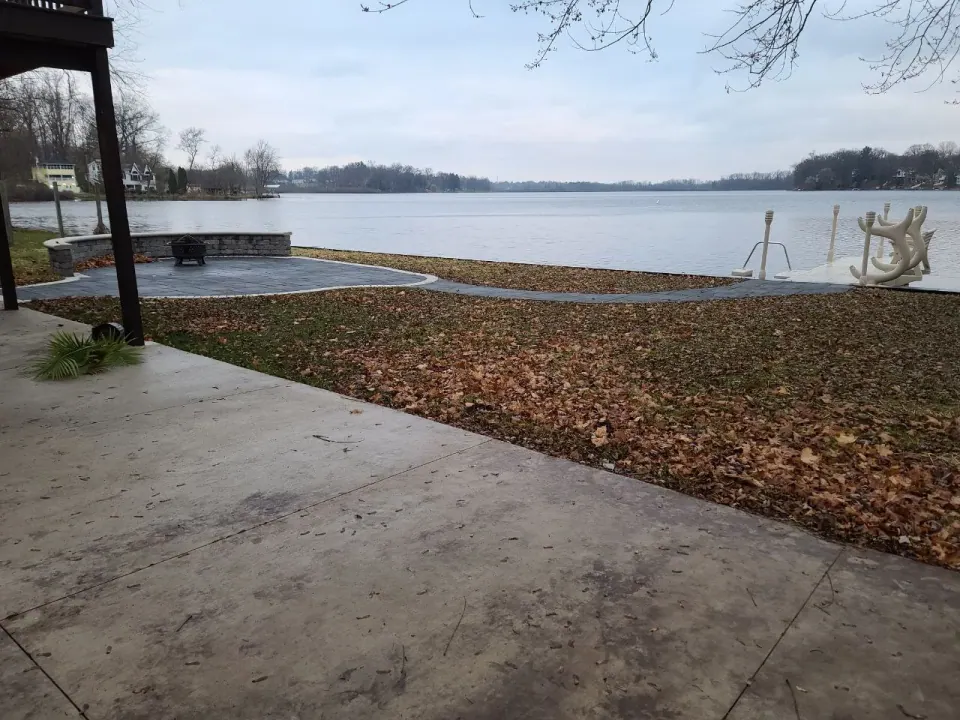A view toward Long Lake and the dock, with the connecting walkway. Patio work by another company.