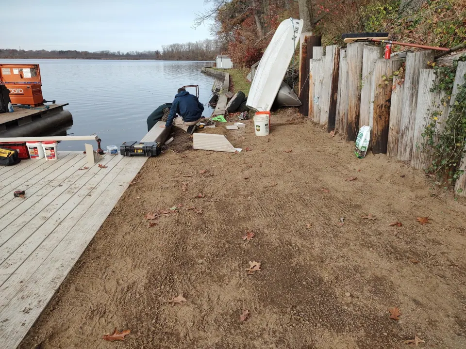 The crew fits the shoreline cap while the bank is being finished.