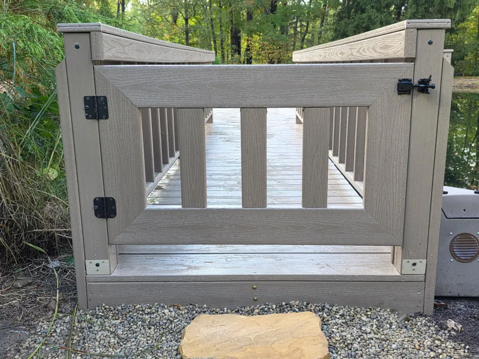 Close view of the matching gate, latch, hinges and walkway railings.