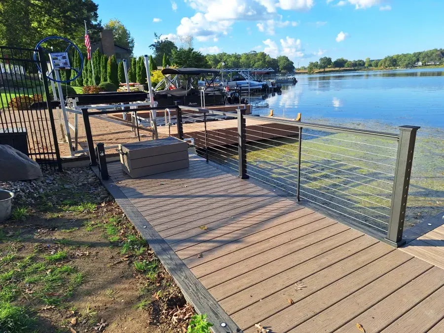Finished WearDeck boardwalk with dark cable railing beside Mud Lake
