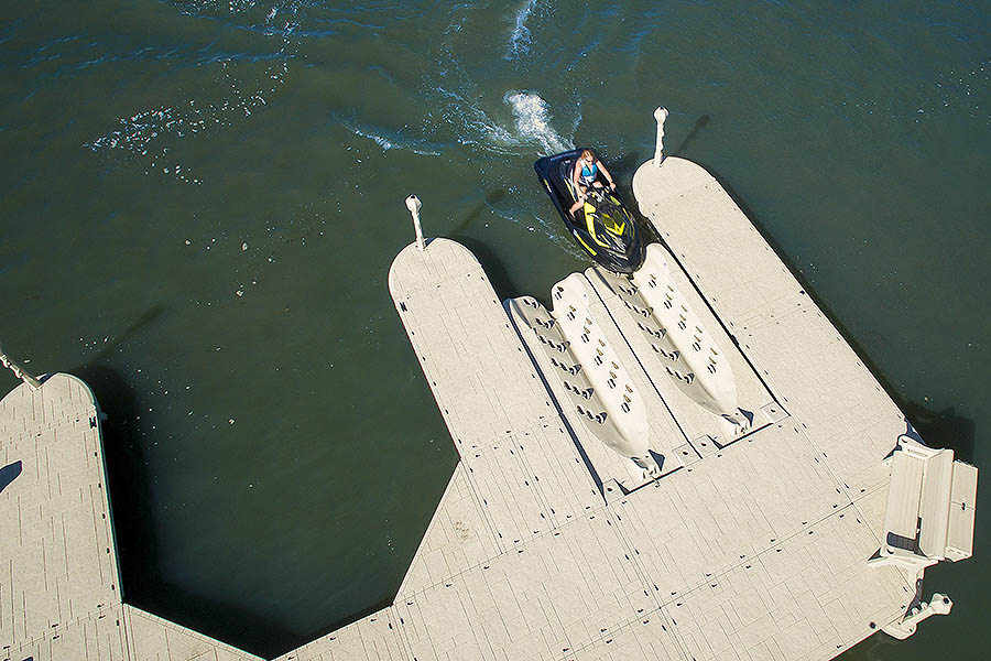 Overhead view of a rider approaching a Wave Armor PWC port between floating dock walkways