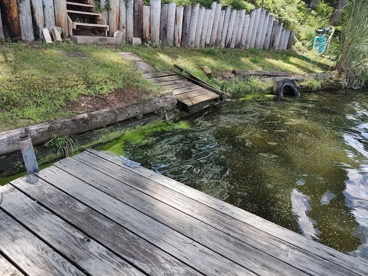 The original timber edge and wooden landing before the project.